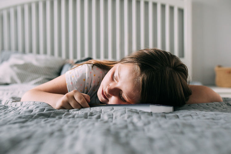Portrait of woman sleeping on bed at home