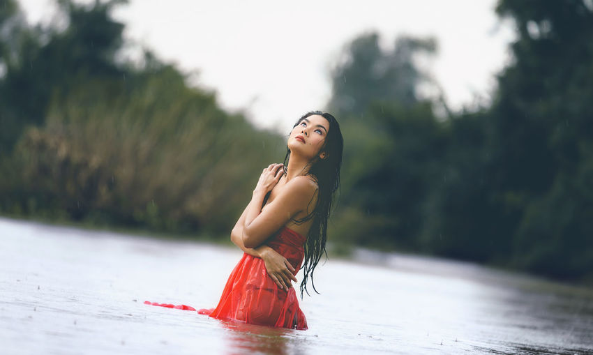 Tilt shot of woman standing in river