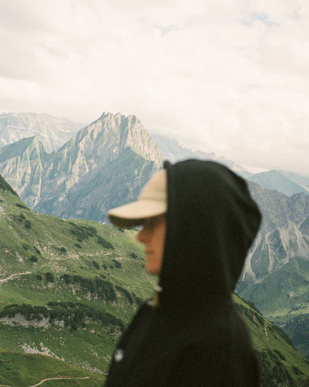 Rear view of girl standing on mountain near oberstdorf, germany. shot on 35mm kodak portra 800 film.
