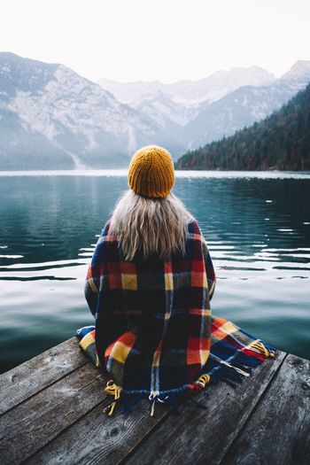 Rear View Mountain Water Lake Beauty In Nature Real People Scenics - Nature Mountain Range Leisure Activity Lifestyles Clothing Sitting Women Nature Day One Person Adult Tranquility Wood - Material Outdoors Looking At View Warm Clothing Hairstyle Alpsee Nature Autumn Mood Capture Tomorrow Moments Of Happiness