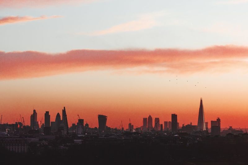 Cityscape against cloudy sky