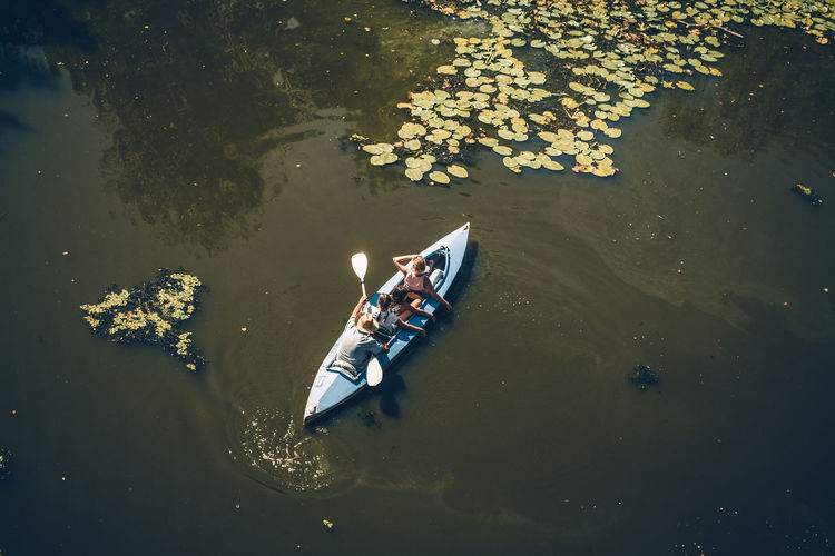 High angle view of people kayaking in lake