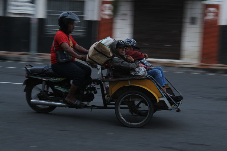 Man riding motorcycle on street