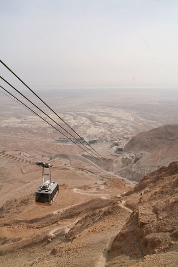 Scenic view of gondola lift and desert against sky in israël