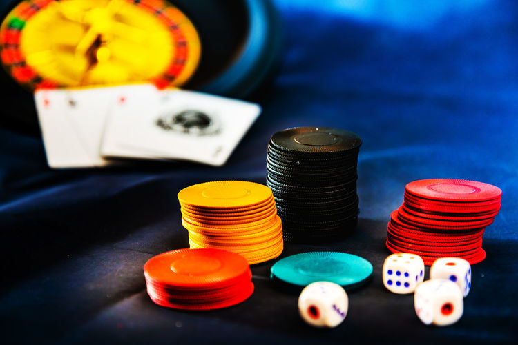 Close-up of gambling chips and dices on table
