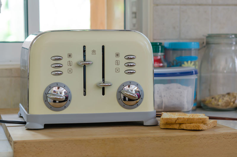 Close-up of toaster on table in kitchen