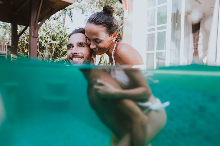 Young couple holding swimming pool