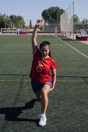 Full length of young woman playing soccer