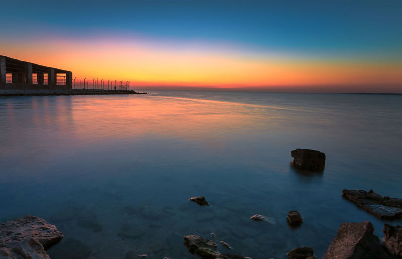Scenic view of sea against sky at sunset