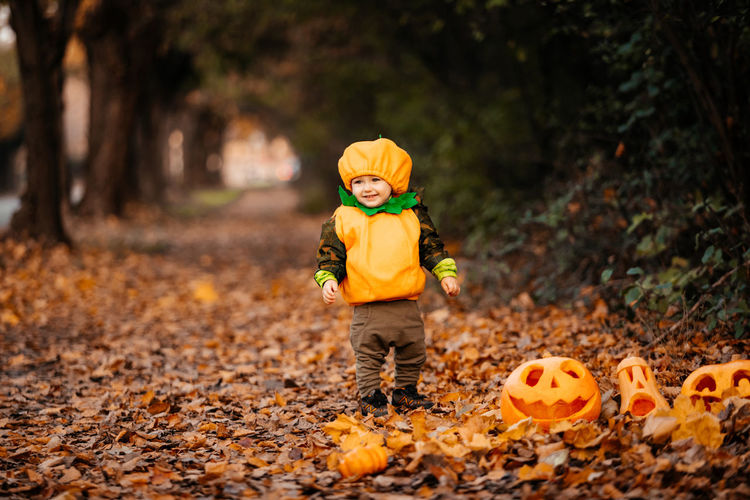 Boy standing on field during autumn