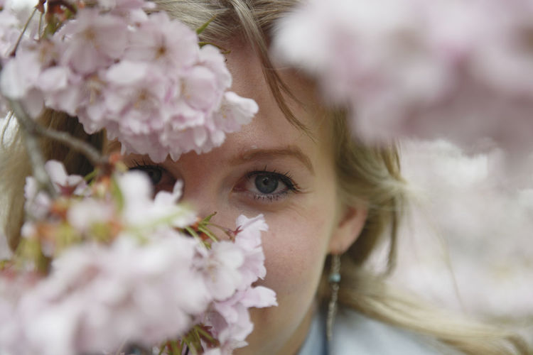 Close-up portrait of girl with pink flowers