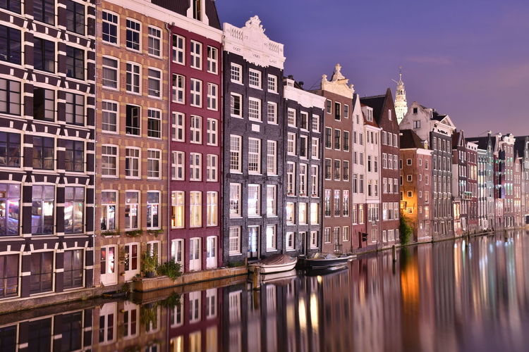 Reflection of buildings on canal in city