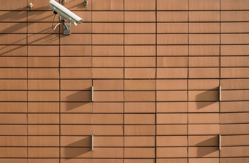 Security camera on brown wall