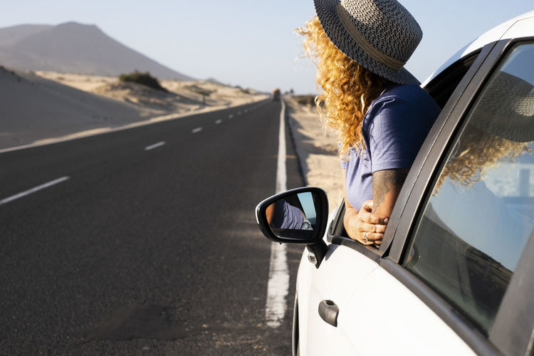 Side view of woman holding car