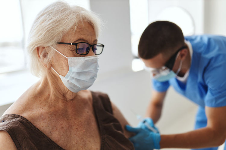 Doctor injecting vaccine to patient
