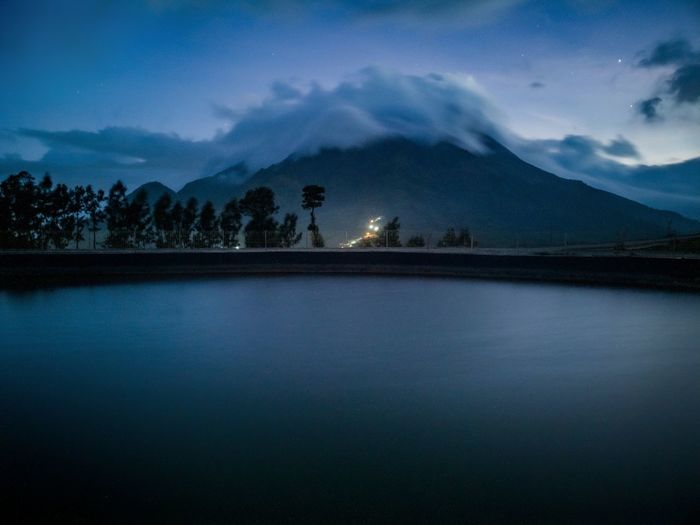 Scenic view of lake and merapi mountain covered by clouds