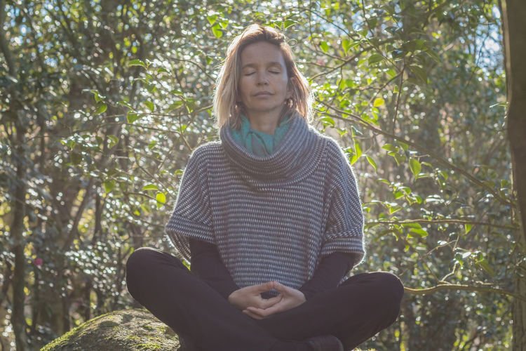 Woman meditating outdoors