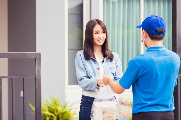 Man delivering food to woman