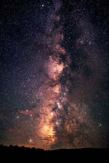 Low angle view of sky against star field at night
