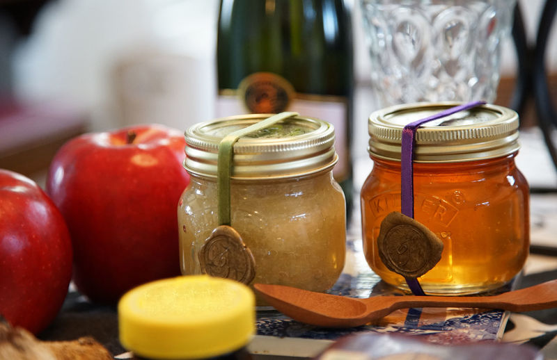 Apples on the table and jam in a glass jar