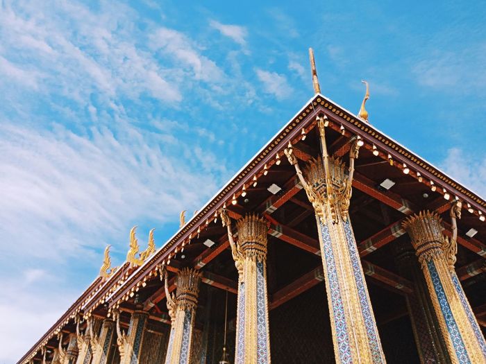 Low angle view of temple against cloudy sky