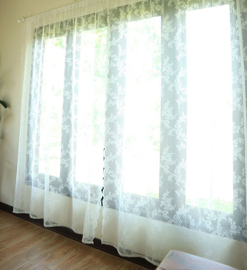 White curtain hanging on floor at home