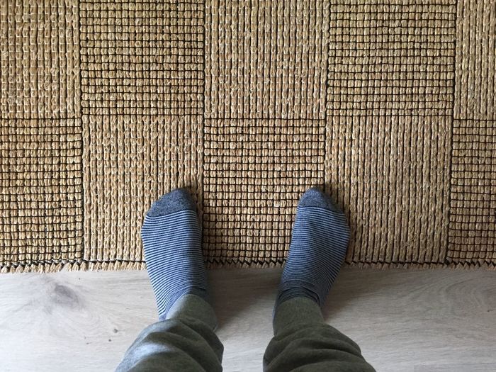 Low section of person standing on doormat