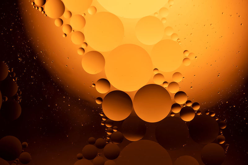Full frame shot of water drops on orange sky