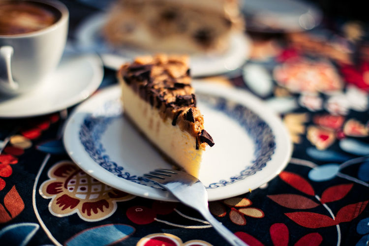 Cheesecake in plate on tablecloth
