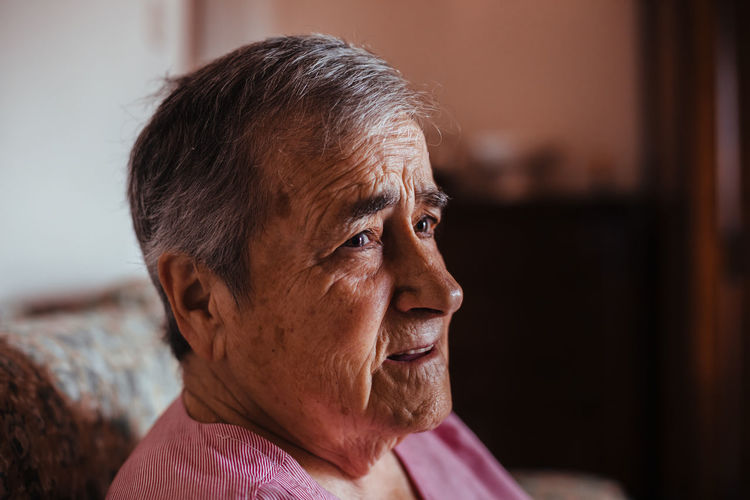 Close-up of woman looking away at home