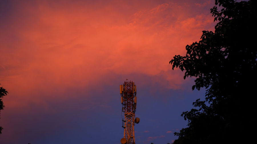 Low angle view of silhouette tower against sky at sunset
