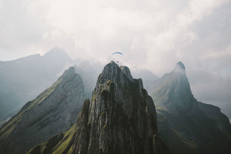 Aerial view of paraglider over mountain range