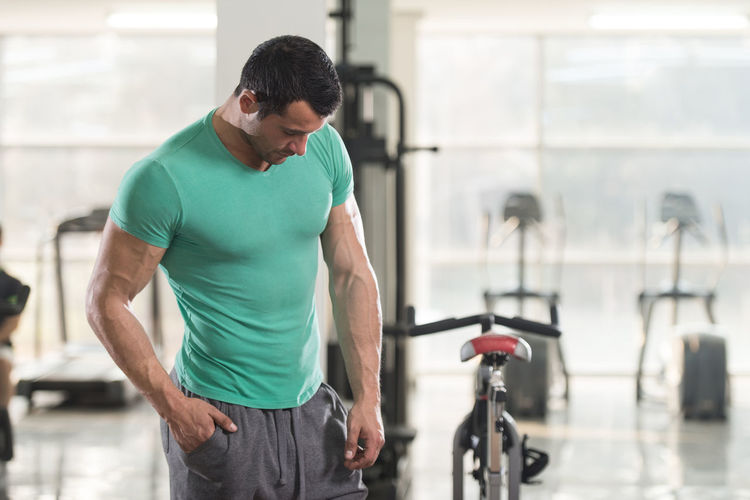 Muscular man standing in gym