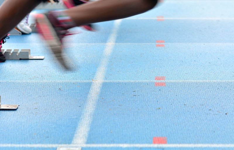 Low section of person running on sport track