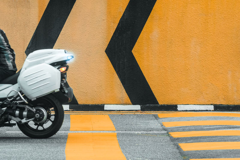 View of scooter on road against wall