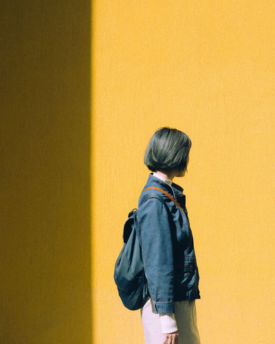 Adult Architecture Casual Clothing Childhood Day Indoors Leisure Activity Lifestyles One Person People Real People Rear View Standing Women Yellow Yellow Background The Fashion Photographer - 2018 EyeEm Awards