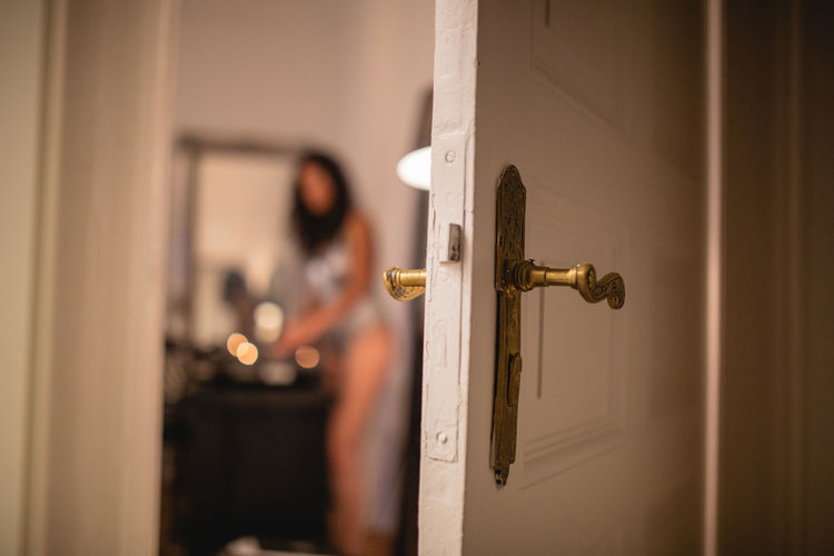 Woman seen through doorway at home