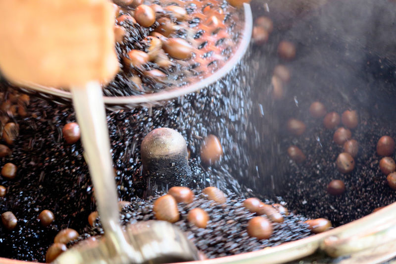 Blurred motion of chestnuts in grinder