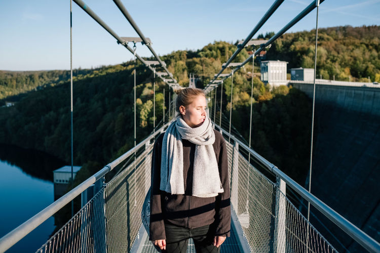Portrait of man standing on footbridge