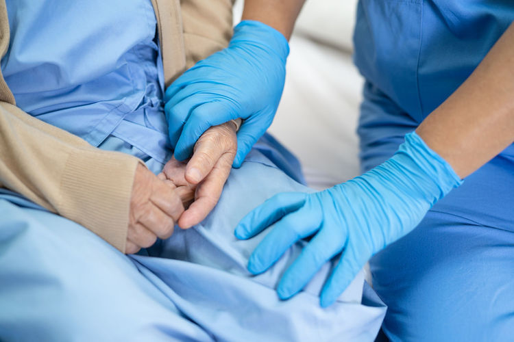 Midsection of woman wearing protective gloves