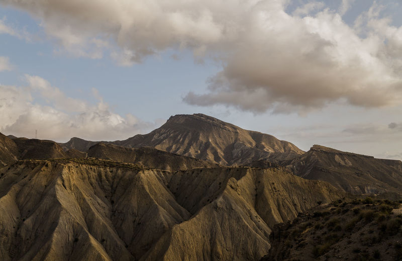 Panoramic view of landscape of tabernas desert in almeria, spain, against cloudy sky