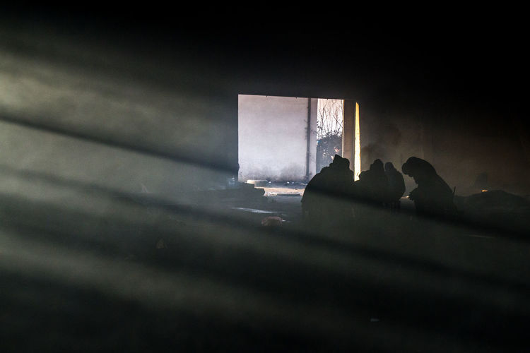 People sitting in dark room during winter