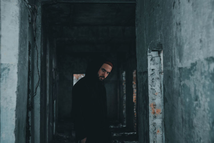 Portrait of man standing in abandoned building