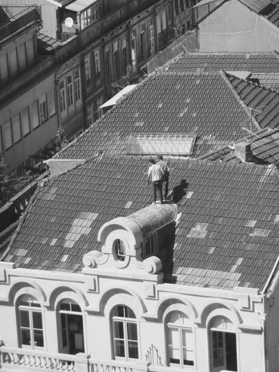 High angle view of men standing on roof of building