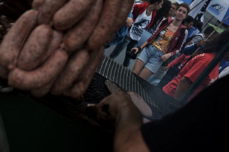 Group of people at sausage food stall