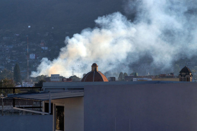 Smoke emitting from chimney against sky