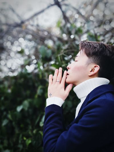 Side view of handsome young man praying