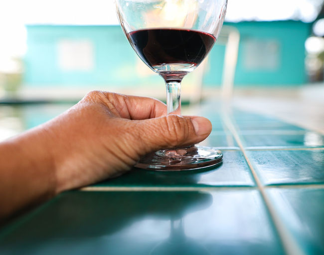 Close-up of hand holding wine glass 
