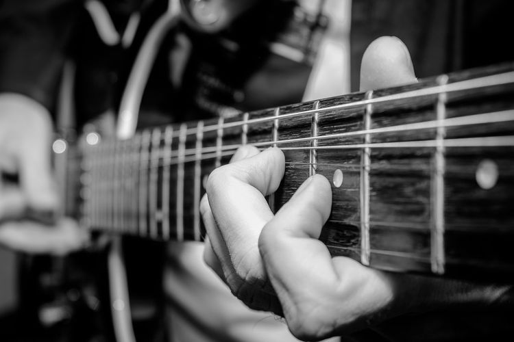 Close-up of man playing guitar