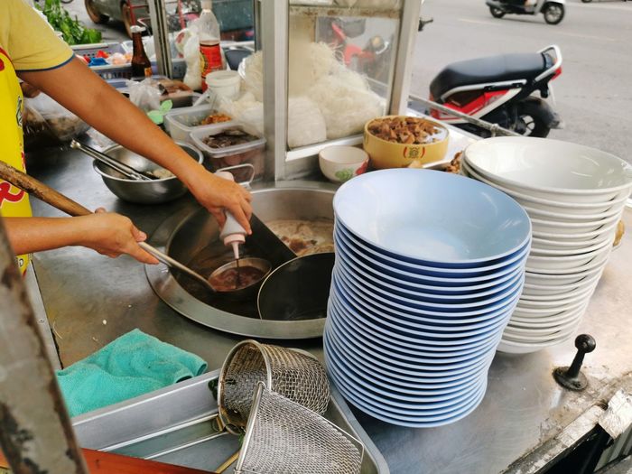 Midsection of man preparing food at stall